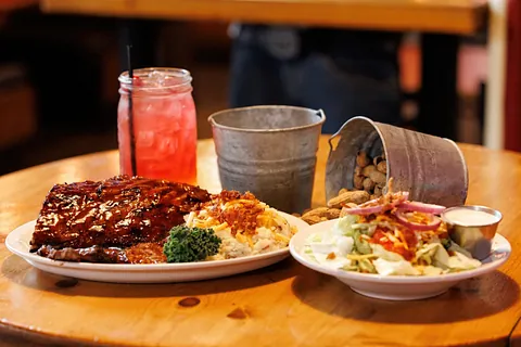 Rack of ribs with a side salad and pink lemonade